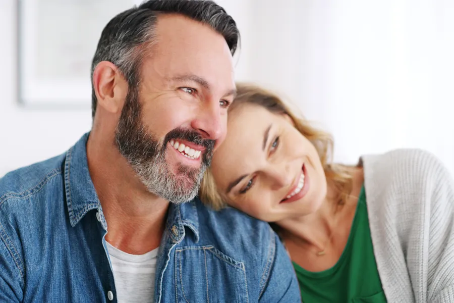 Concierge-Medicine-Clinic A middle-aged white couple in a bright white room smile and lay their heads on each other. Schedule concierge health and wellness services from Susan Ashley, M.D. in Spokane, Washington.